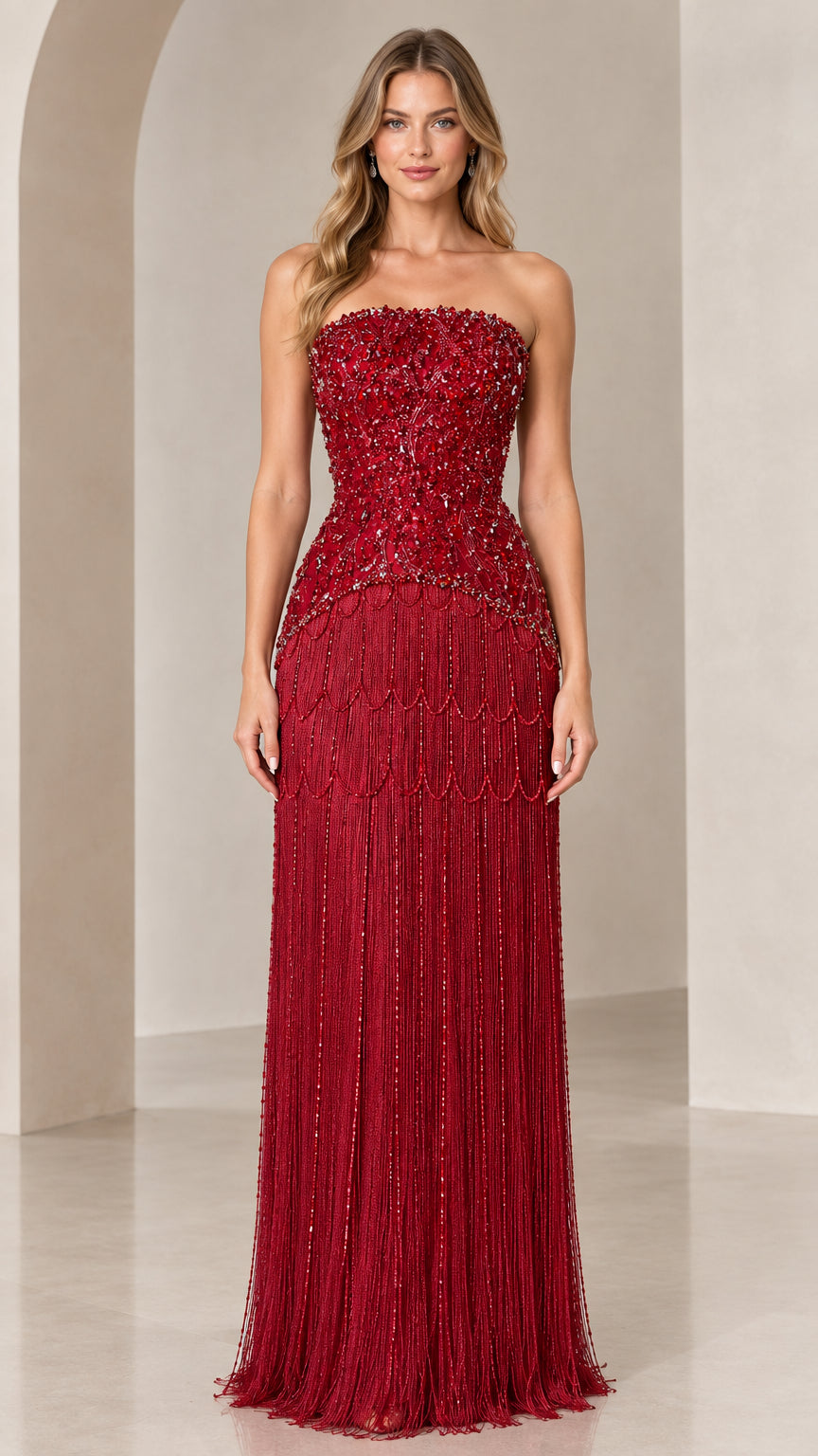 Front view of model wearing burgundy strapless beaded fringe evening gown
