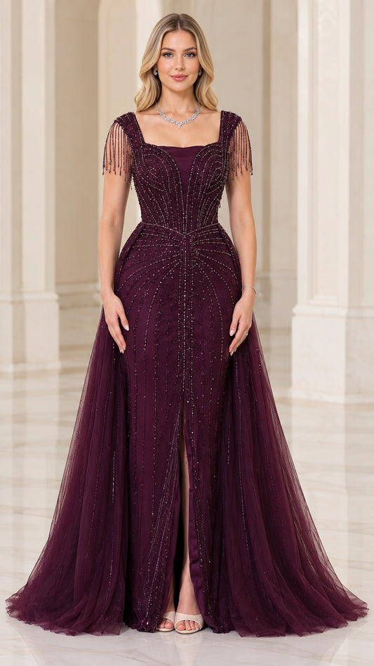 Front view of woman wearing burgundy square neck beaded evening gown with front slit and tulle overskirt