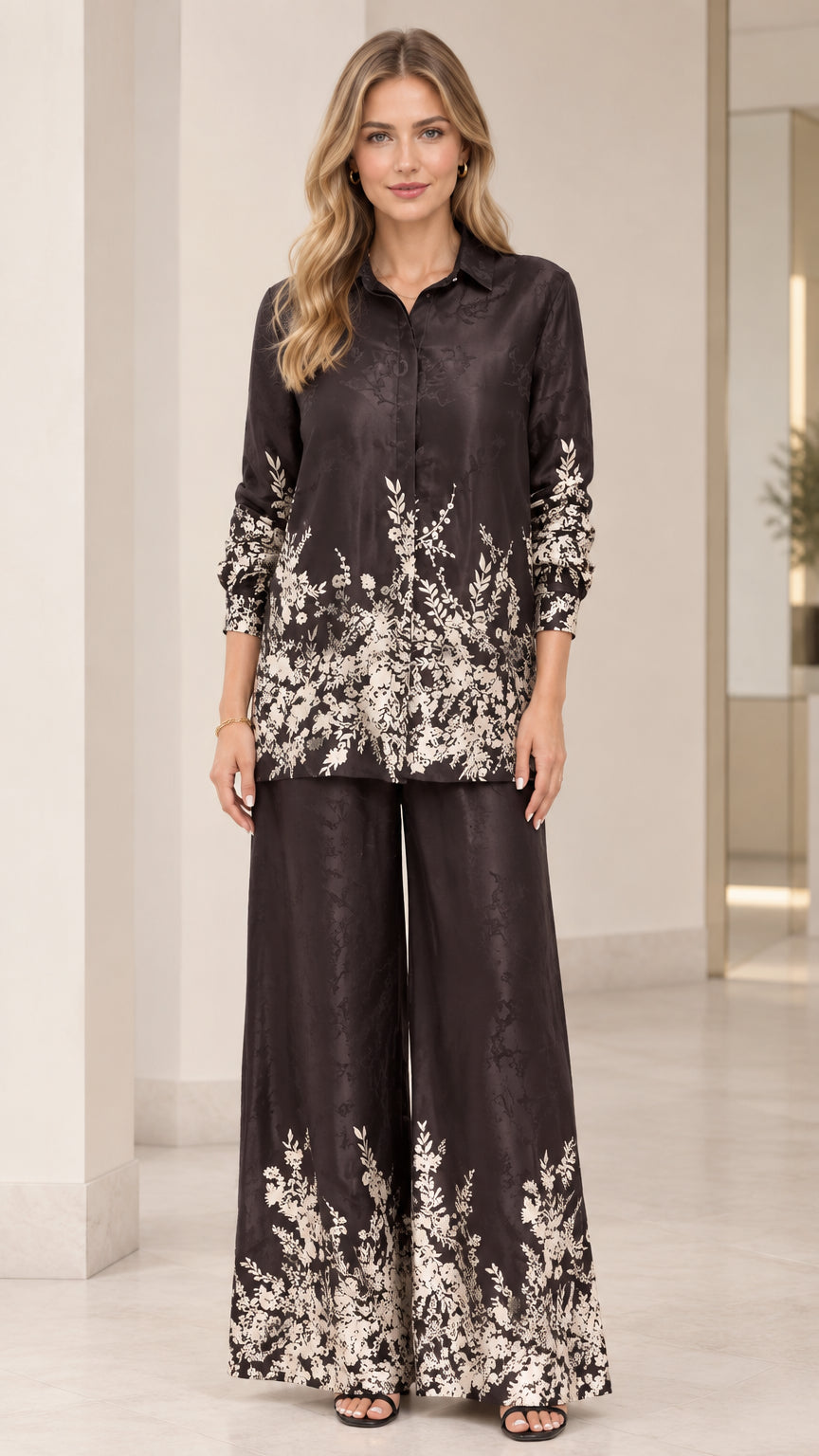 Front full view of women's floral satin two-piece set in black with collared shirt and wide-leg pants