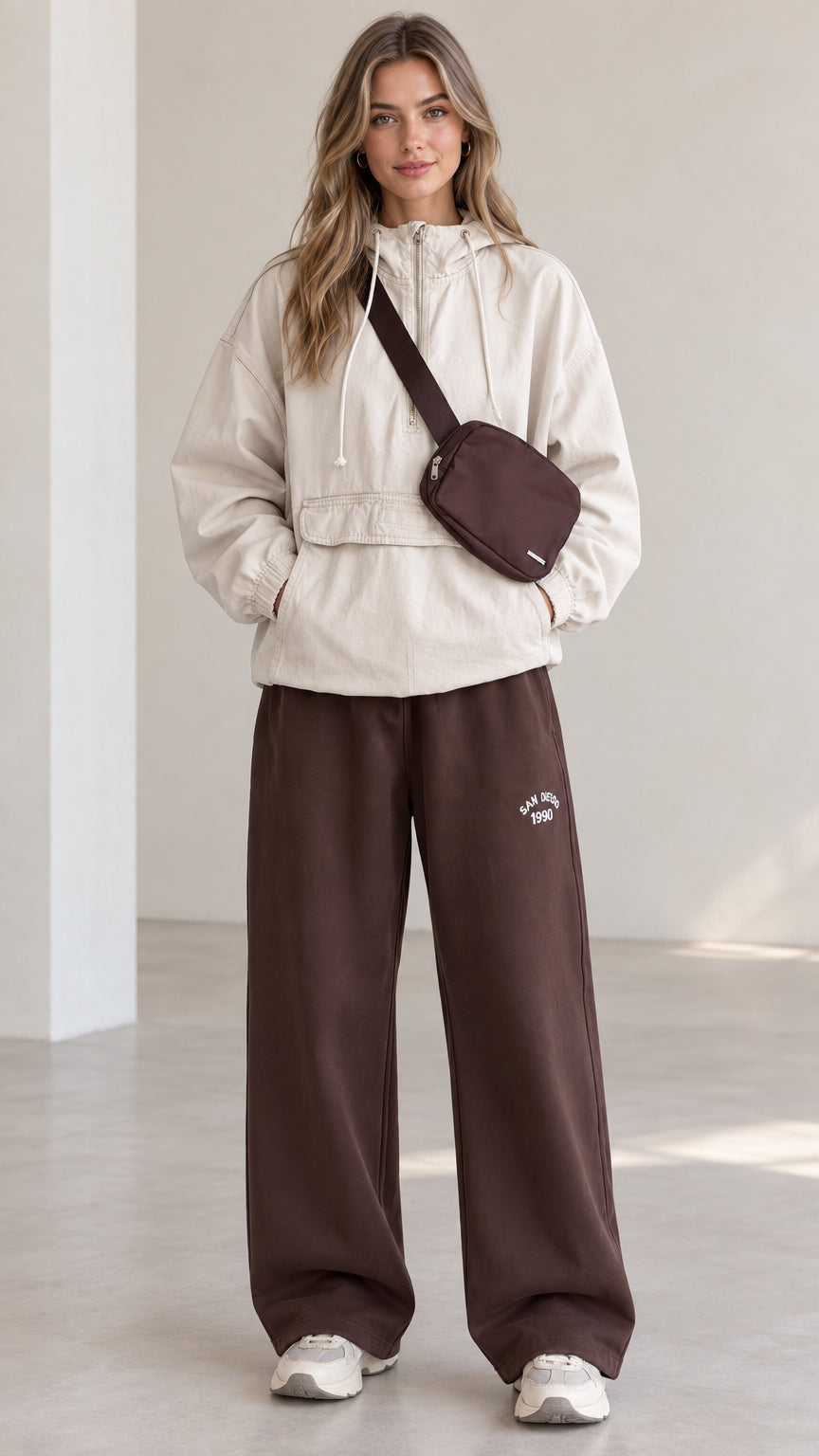 Front full-length view of model wearing beige half-zip hooded anorak pullover jacket