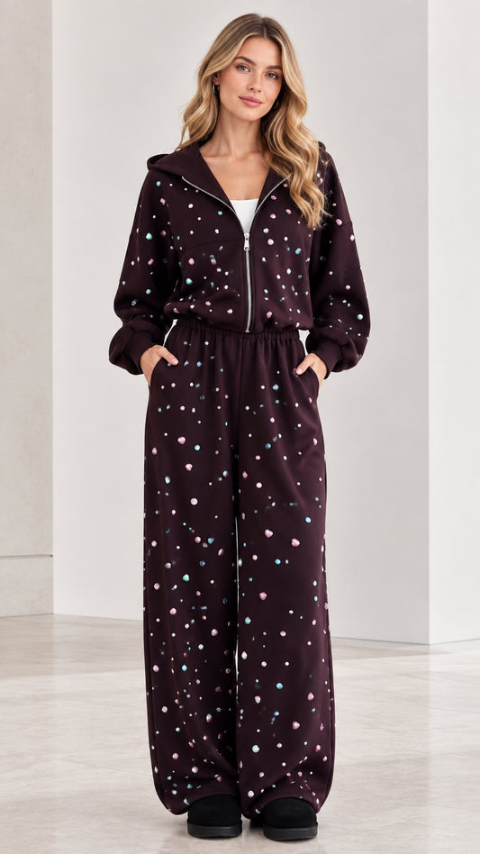 Front view of woman wearing burgundy rhinestone zip-up hooded wide leg jumpsuit