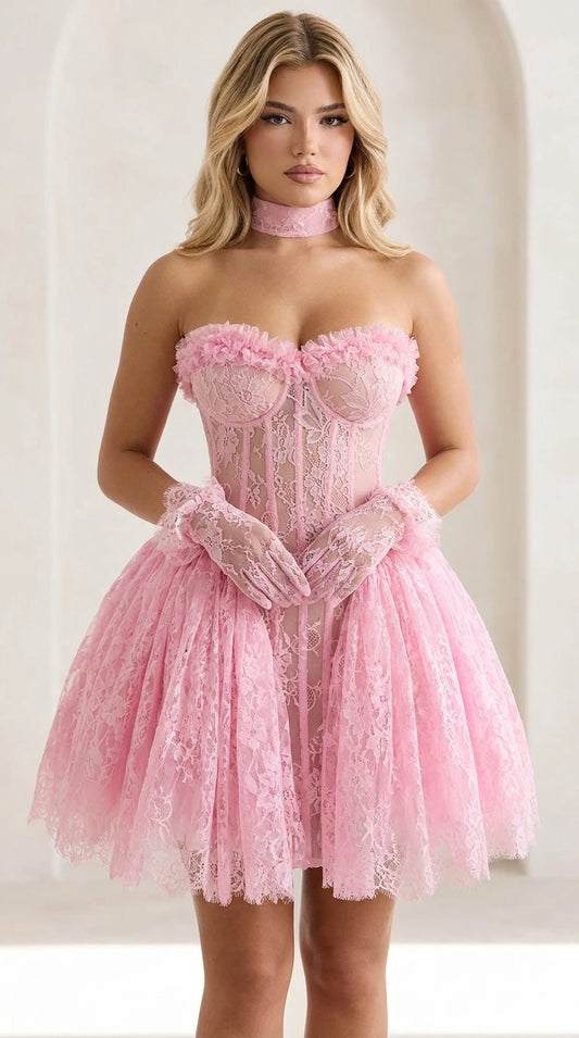 Front view of model wearing pink lace corset mini dress with matching gloves