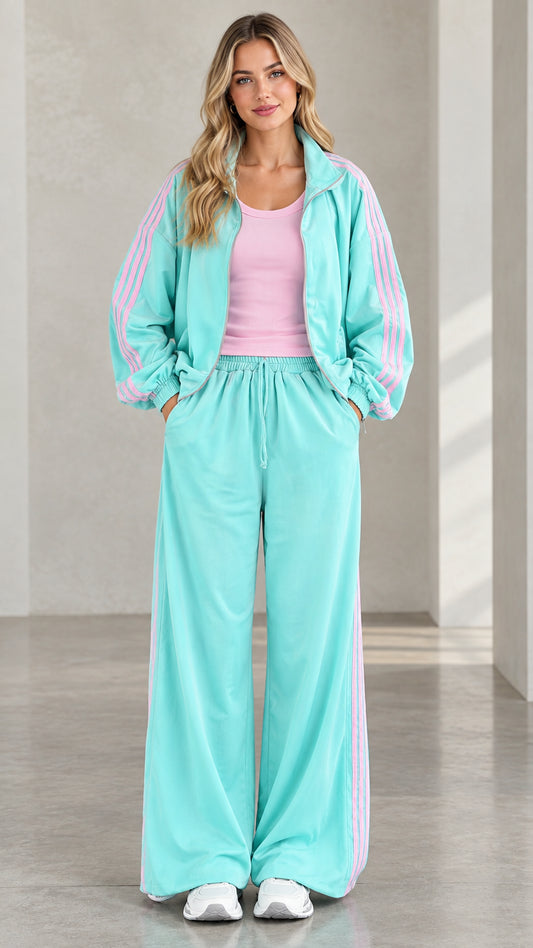 Front view of model wearing mint green two-piece tracksuit set with pink side stripes