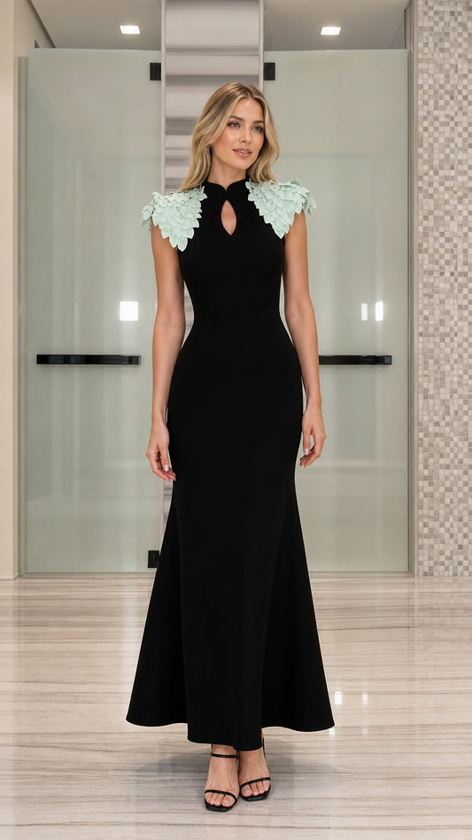 Front view of black mermaid evening dress with mint green petal shoulder embellishments