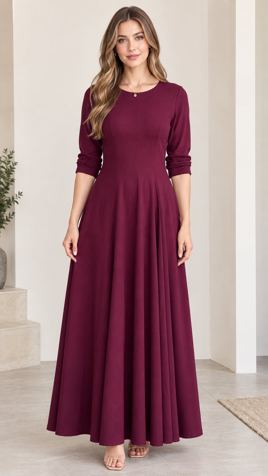 Front view of woman wearing elegant burgundy 3/4 sleeve A-line maxi dress