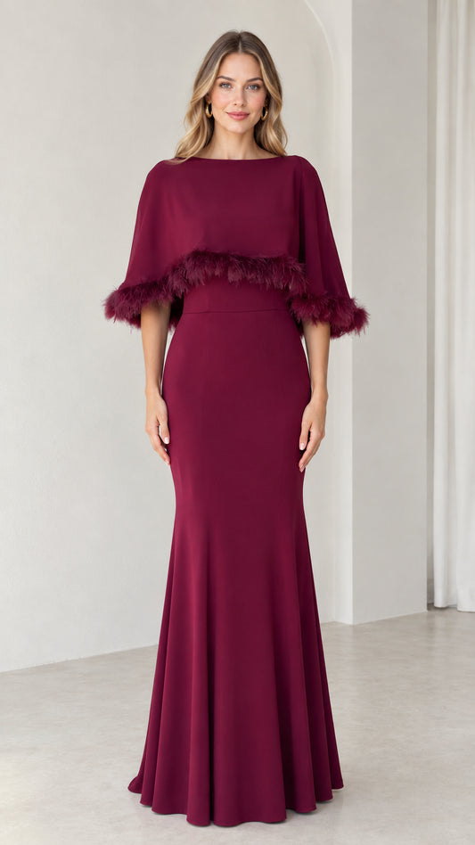 Front view of burgundy mermaid evening dress with feather trim capelet