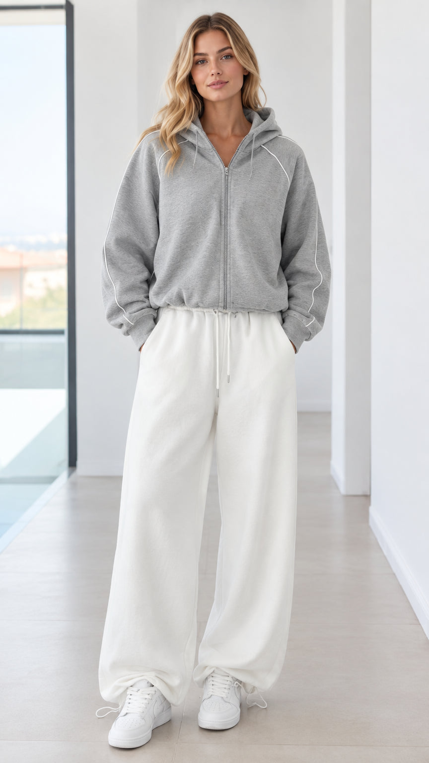 Full front view of model wearing heather grey zip hoodie and off-white wide-leg sweatpants