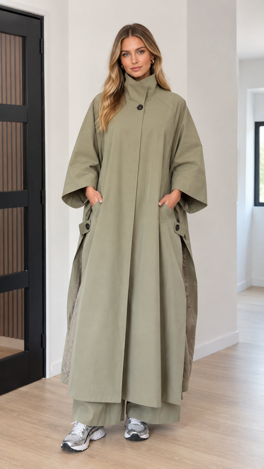 Front full-length view of woman wearing oversized sage green maxi cape coat
