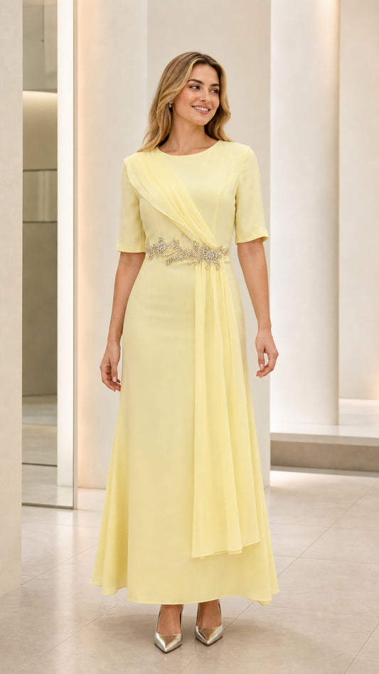 Full front view of model wearing pastel yellow short sleeve maxi formal dress with beaded waist