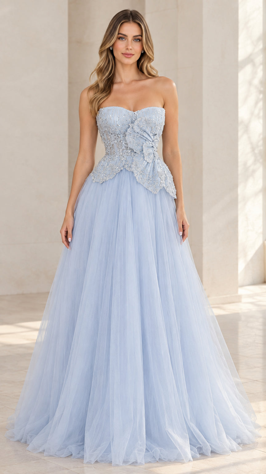 Front view of model wearing light blue strapless beaded tulle ball gown