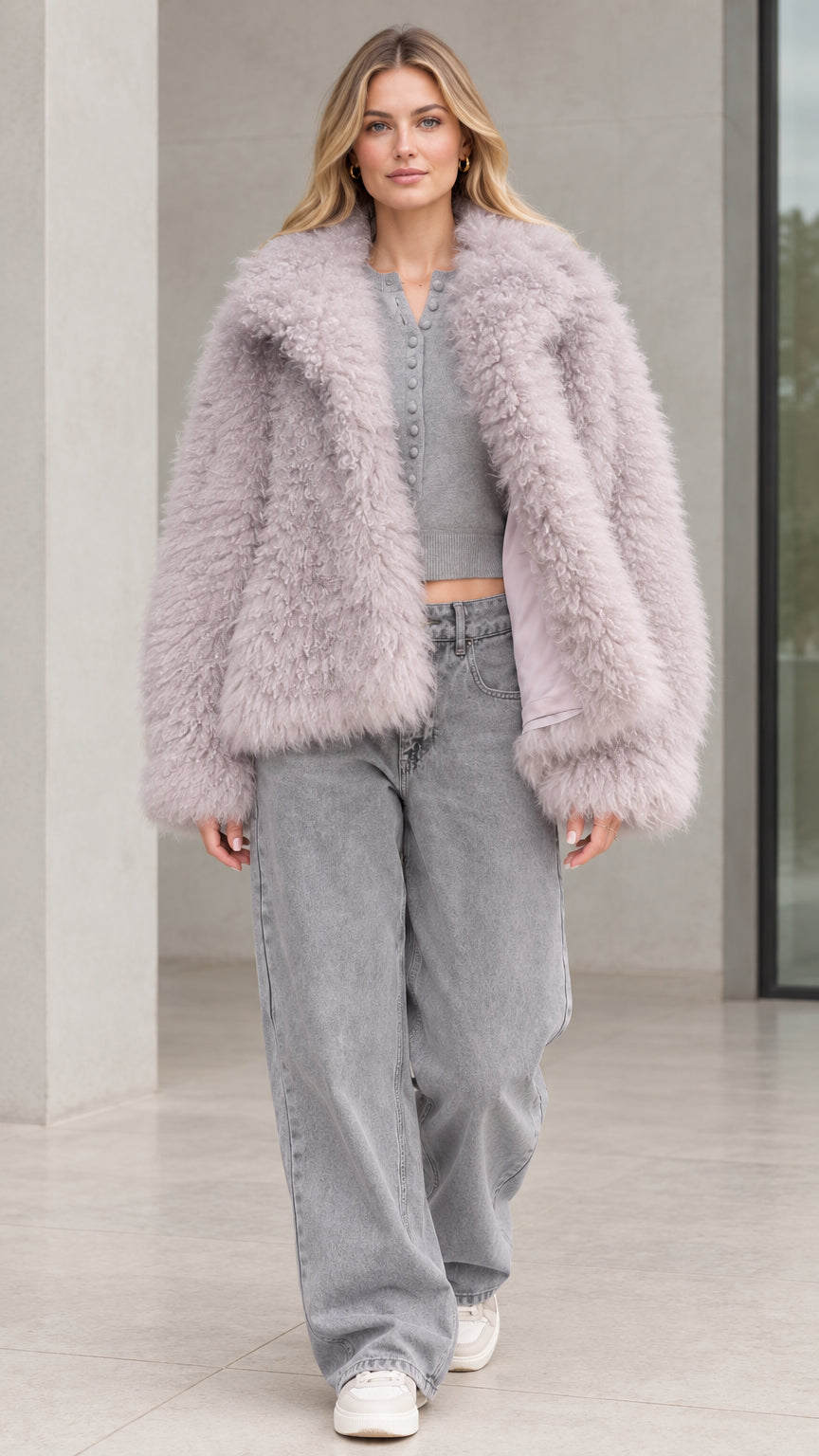 Front view of model wearing dusty lilac textured shaggy faux fur jacket with wide-leg jeans