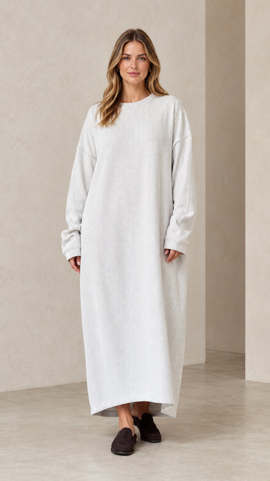 Front view of woman wearing oversized light grey ribbed knit maxi dress