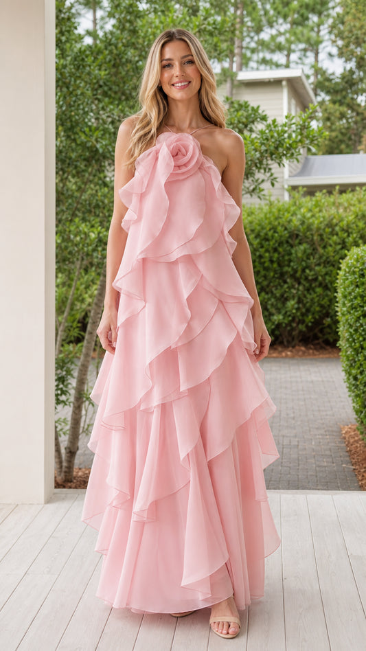 Front view of model wearing pink halter rosette ruffle maxi dress