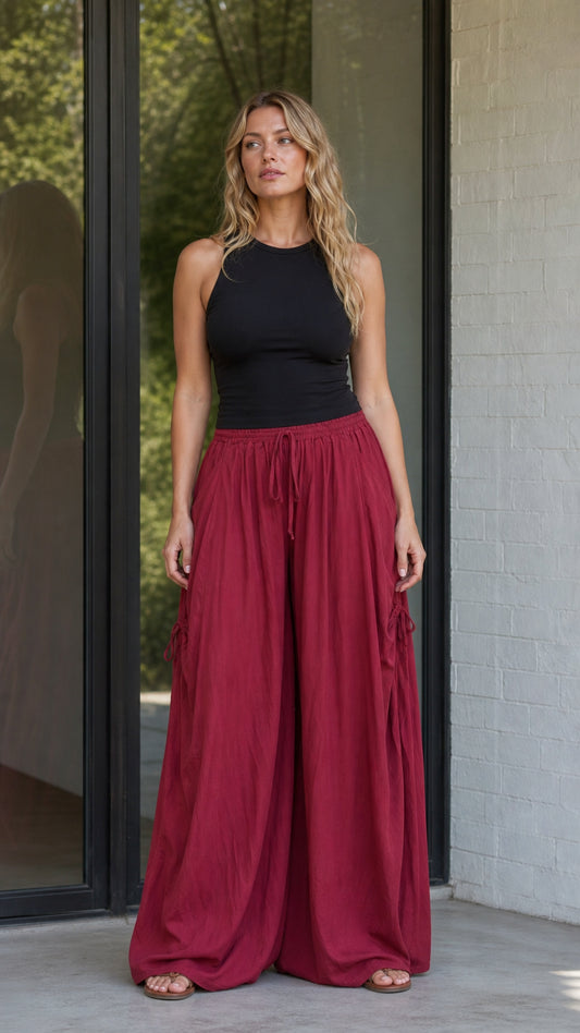 Front view of woman wearing burgundy wide-leg drawstring pants