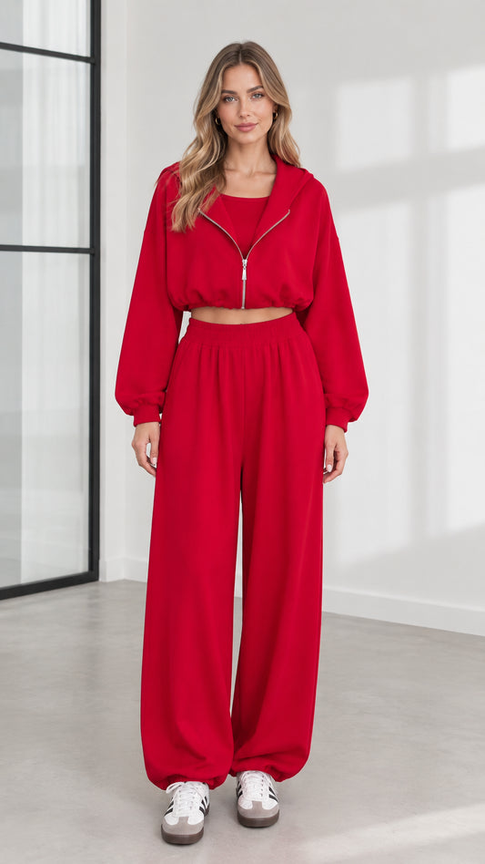 Front view of model wearing women's red 3-piece cropped zip hoodie and wide-leg lounge set