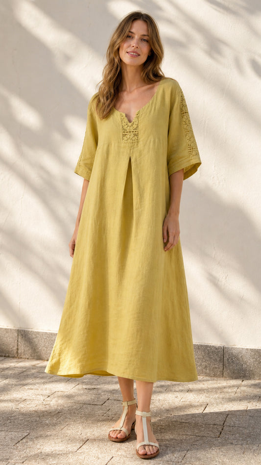 Front view of model wearing yellow midi dress with crochet details