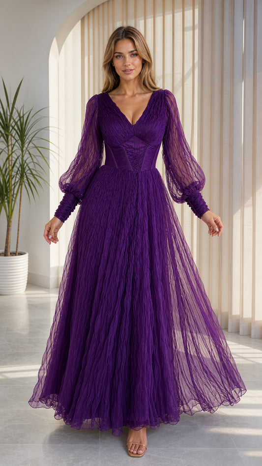 Front view of model wearing purple tulle maxi dress with sheer bishop sleeves and corset bodice