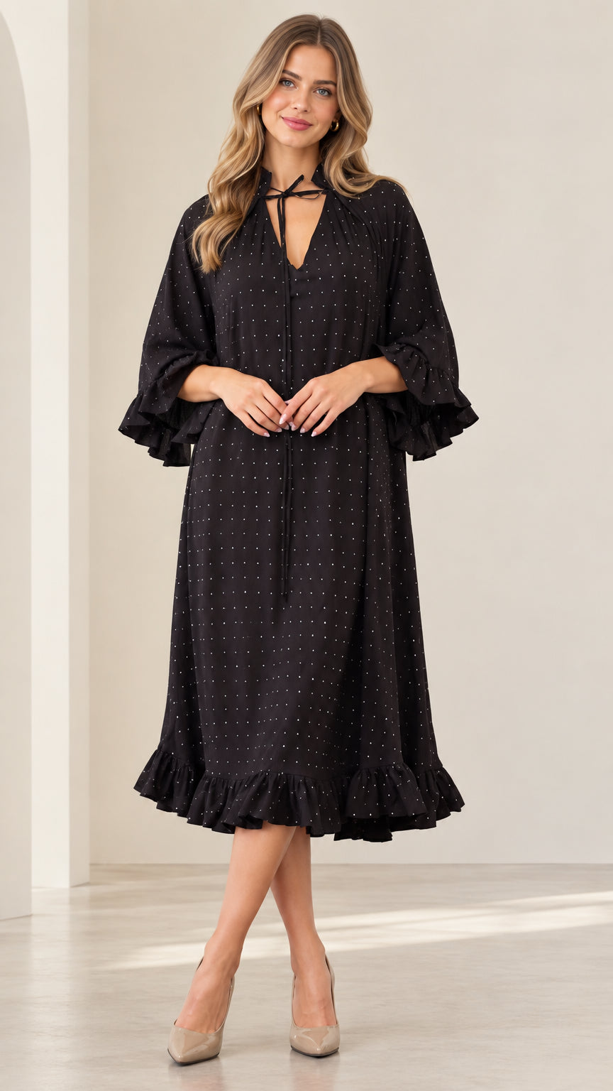 Front view of woman wearing black sparkle tie-neck midi dress with ruffle sleeves