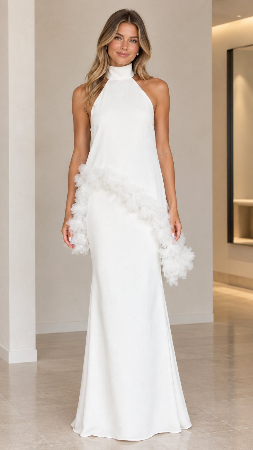Front view of model wearing floor-length white halter neck maxi dress with diagonal ruffle trim
