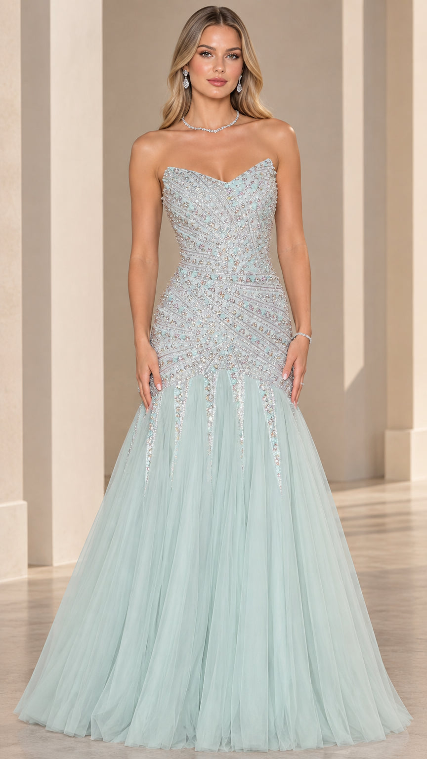 Front view of model wearing strapless beaded mermaid gown in mint green with flared tulle skirt