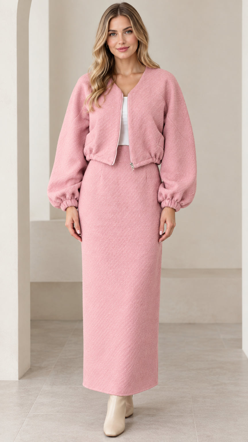 Front view of model wearing pink textured cropped jacket and matching maxi skirt set