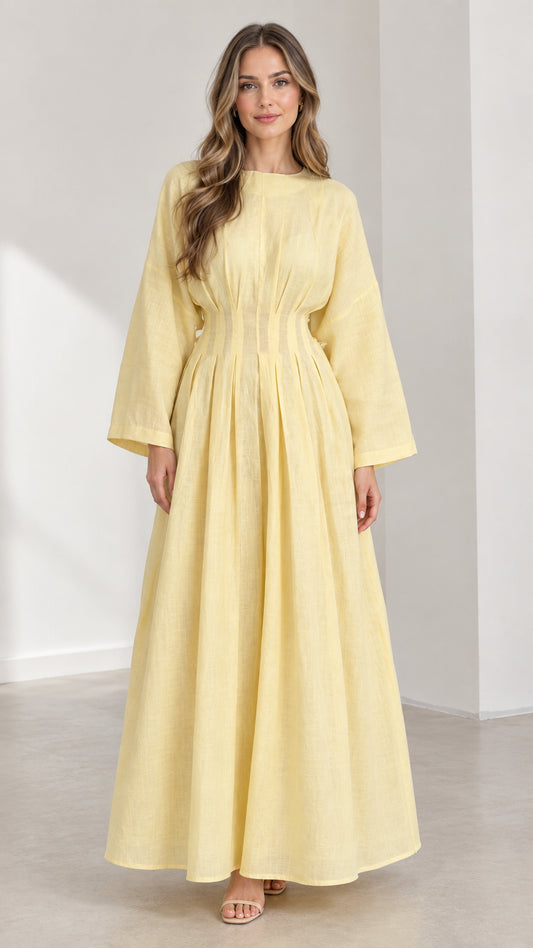 Front view of woman wearing Light Yellow long sleeve pleated waist maxi dress