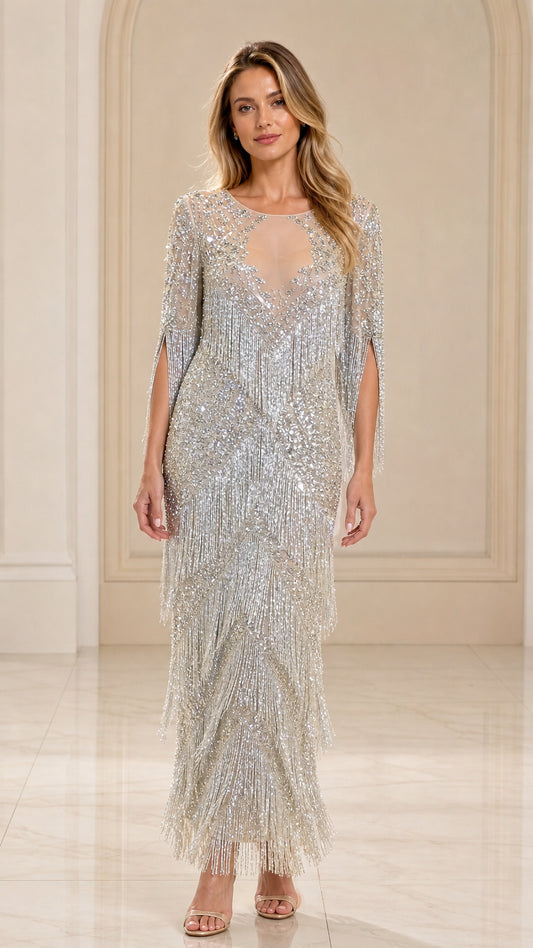 Front view of woman wearing silver sequin beaded fringe maxi gown with illusion neckline