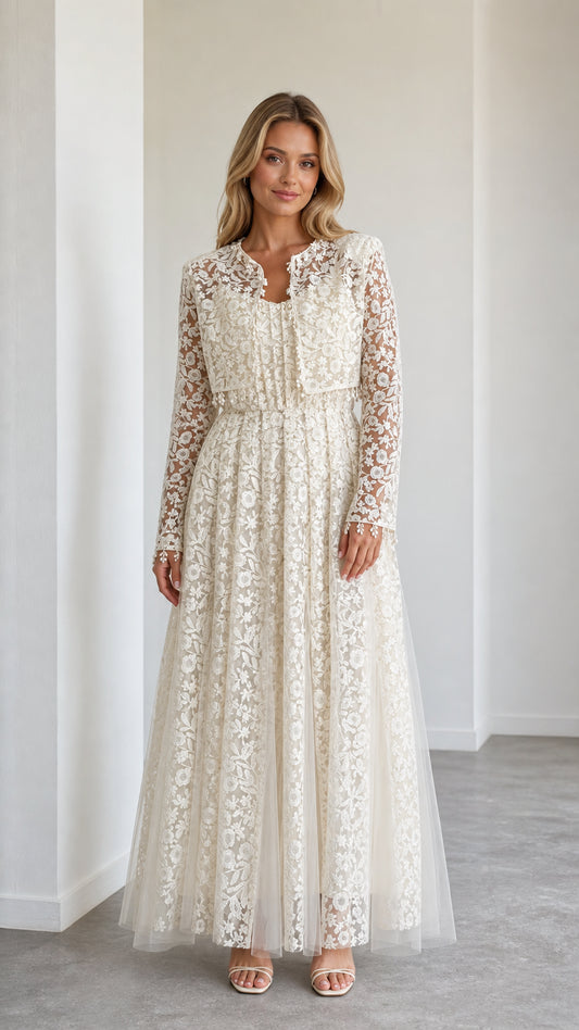 Front view of model wearing ivory floral lace maxi dress with cropped jacket