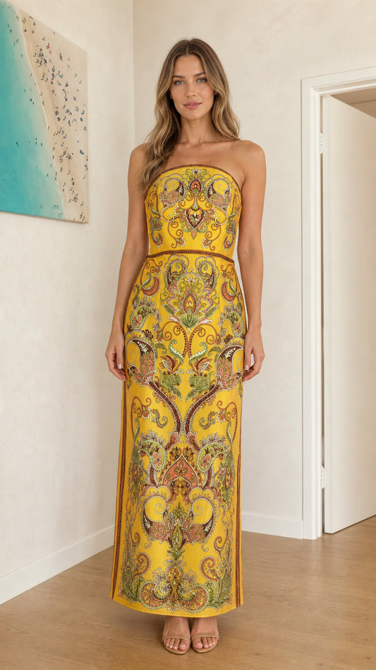 Front view of model wearing yellow paisley strapless maxi dress