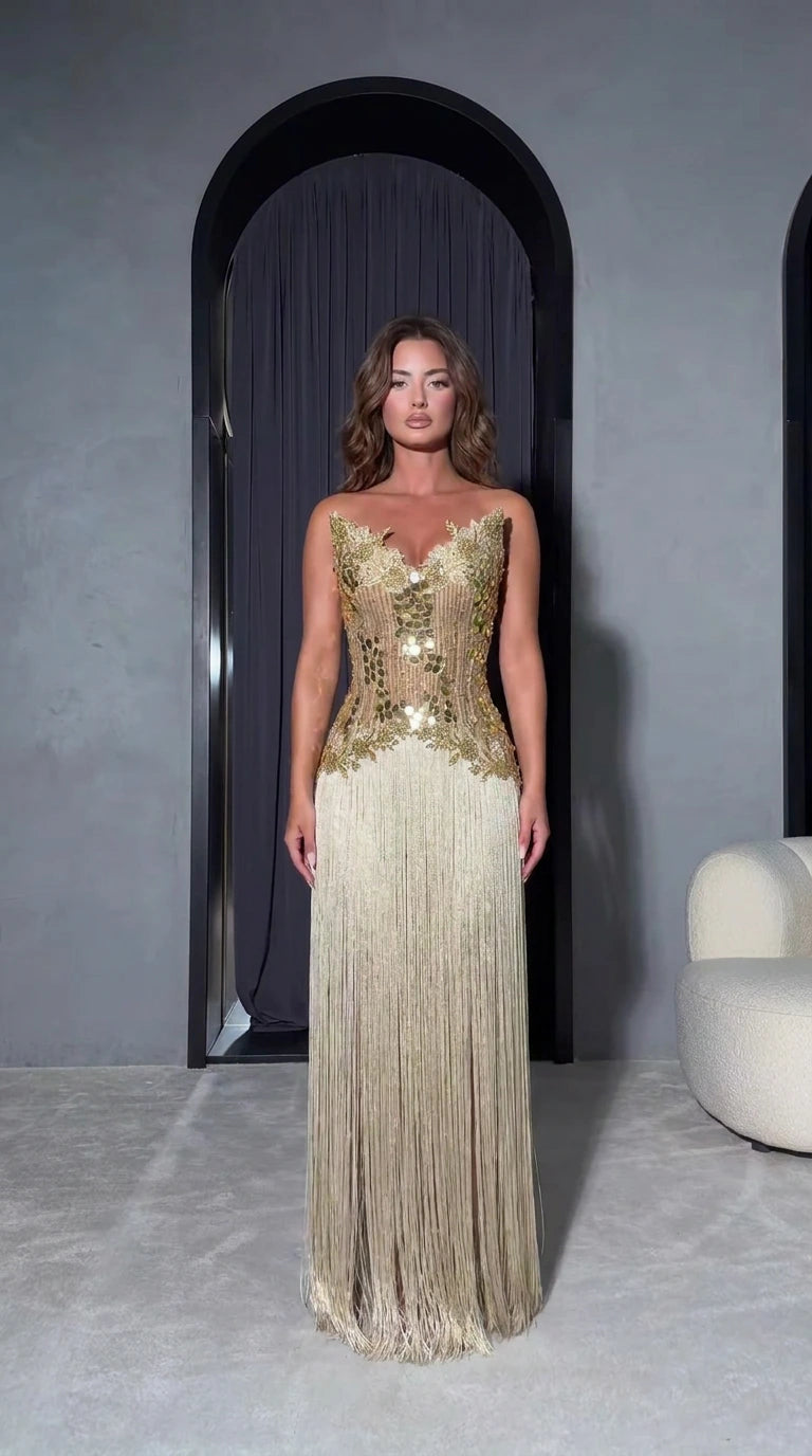 Front full-length view of model wearing Champagne Gold strapless embellished fringe maxi evening dress