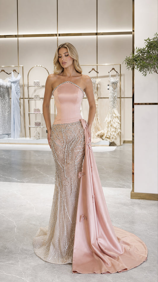 Front view of pink strapless sequin mermaid evening gown with side drape