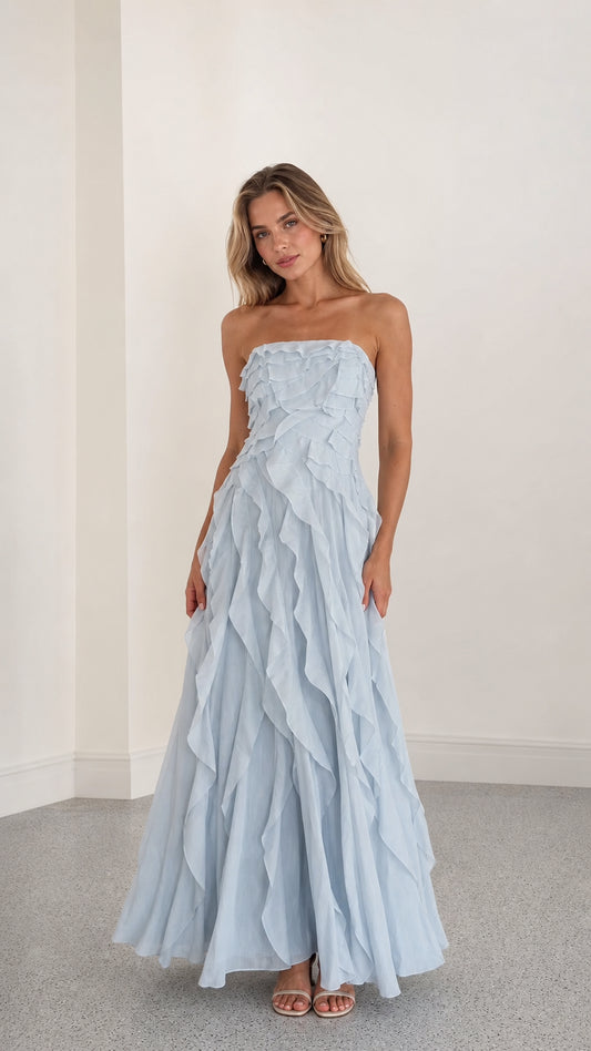 Front view of model wearing light blue strapless ruffle maxi dress
