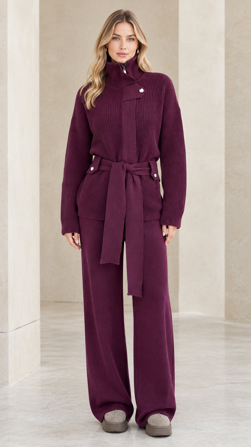Front full-length view of woman wearing plum ribbed knit belted sweater and matching wide-leg pants set