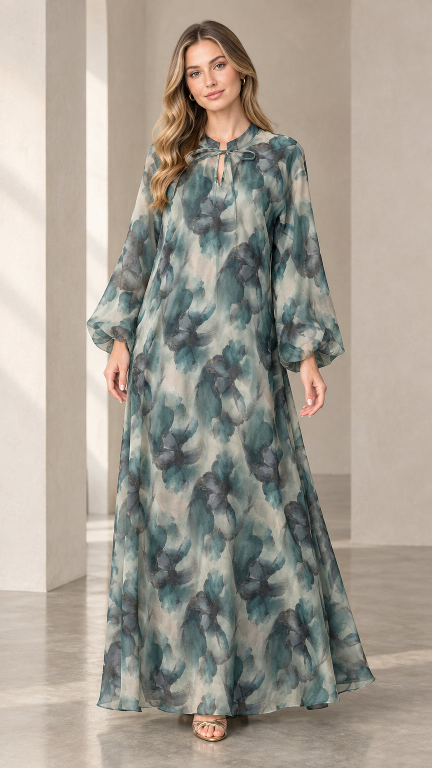 Front view of woman wearing a sage green watercolor floral chiffon maxi dress with long balloon sleeves