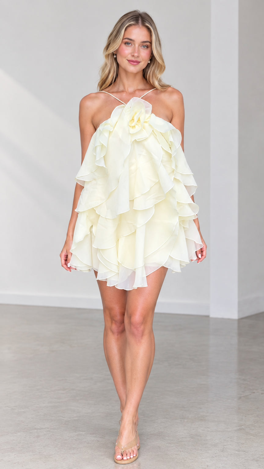 Full front view of model wearing Butter Yellow halter tiered ruffle mini dress with 3D rosette