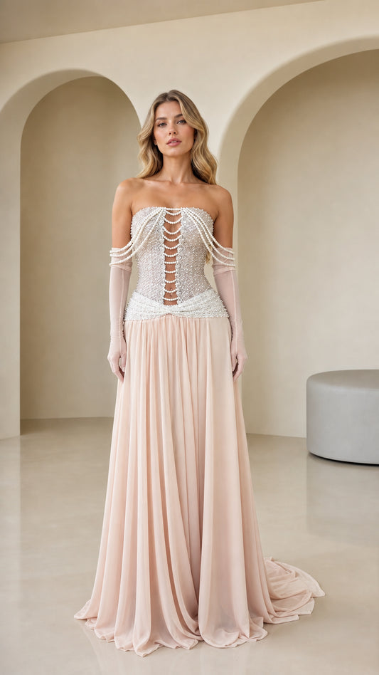 Front view of Blush Pink strapless evening gown with pearl corset bodice and flowing chiffon skirt