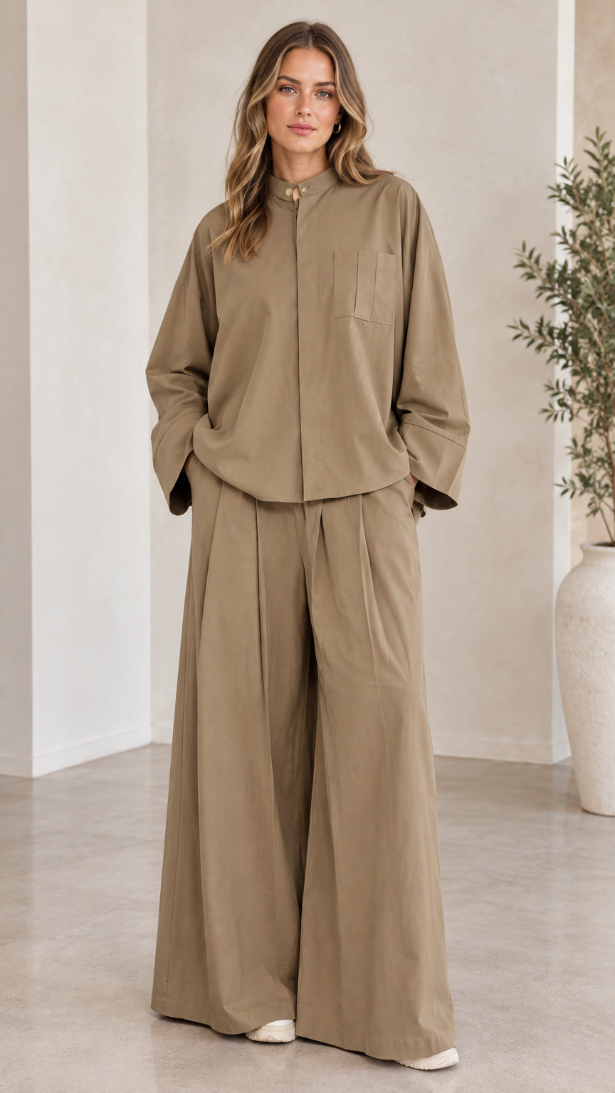 Front full-length view of woman wearing khaki two-piece shirt and wide-leg pants set
