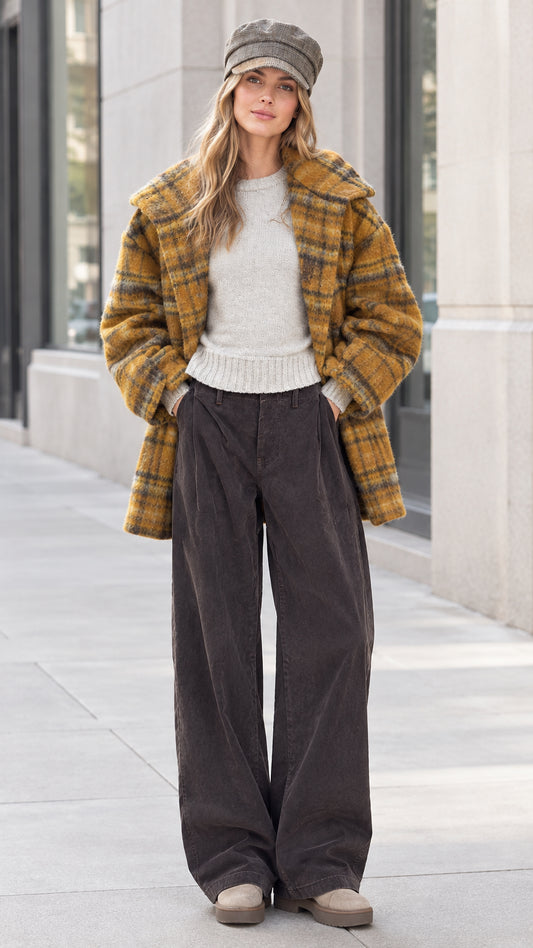 Front view of model wearing mustard yellow plaid mid-length coat with wide-leg pants