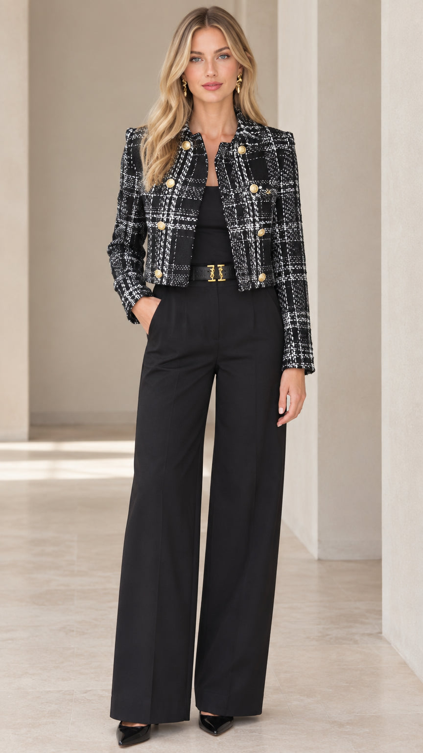 Front view of model wearing black and white plaid cropped tweed jacket with gold buttons