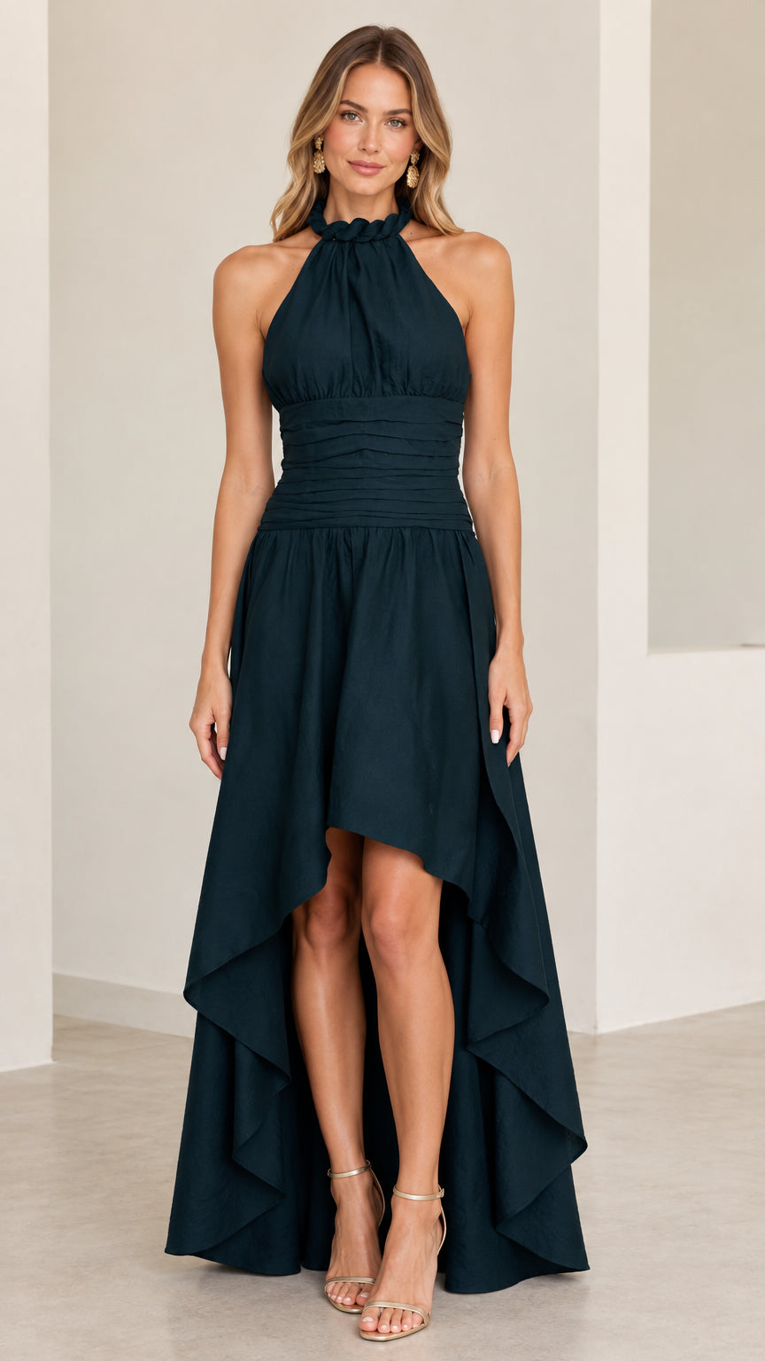 Front view of model wearing dark green halter neck high-low evening dress