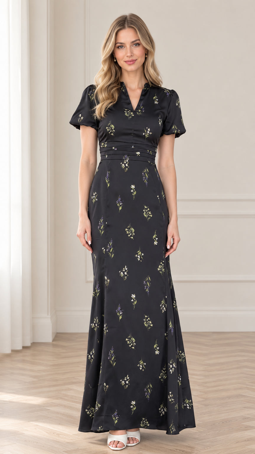 Front view of model wearing black floral print maxi dress with pleated waist and puff sleeves