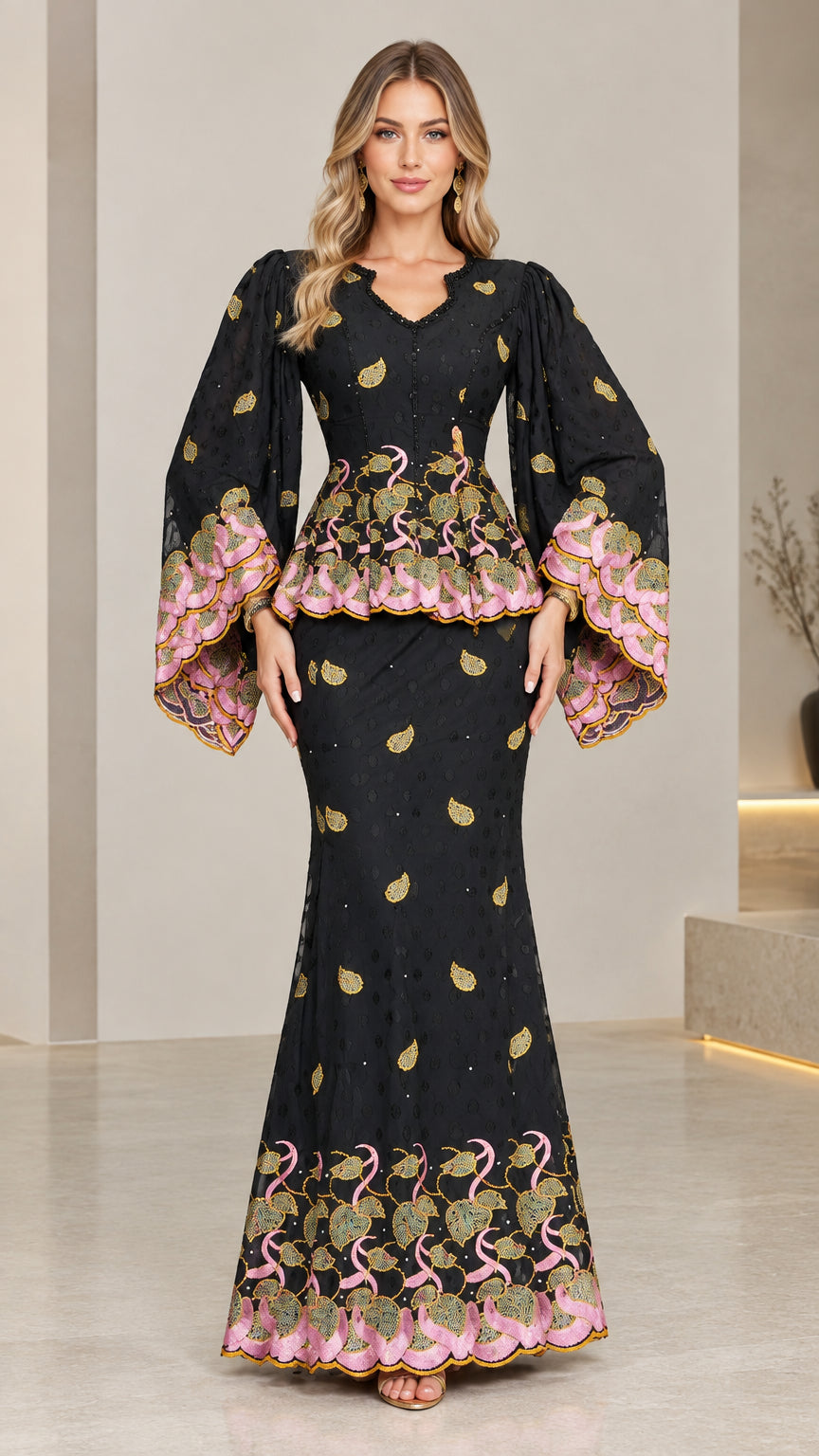 Front view of model wearing black embroidered peplum maxi dress with flared sleeves