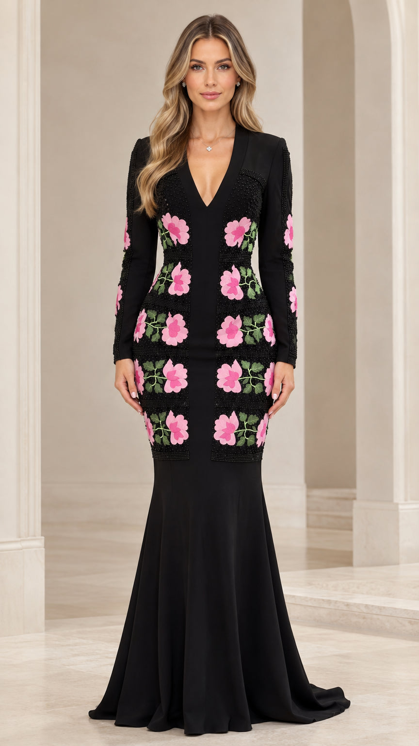 Front view of black long sleeve mermaid evening gown with pink floral applique details