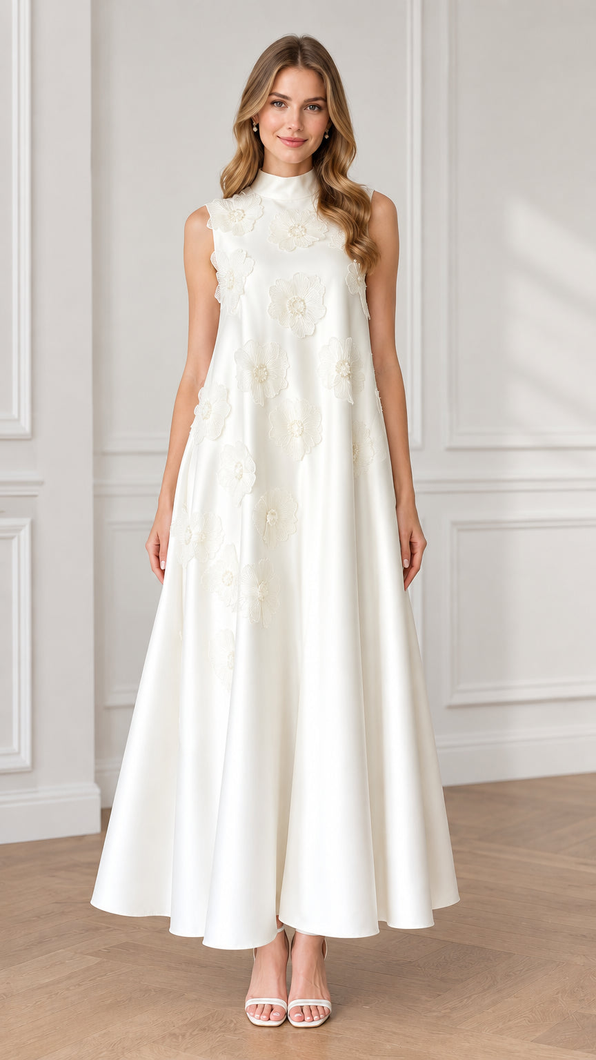Front view of model wearing white high neck sleeveless maxi dress with 3D floral appliqués