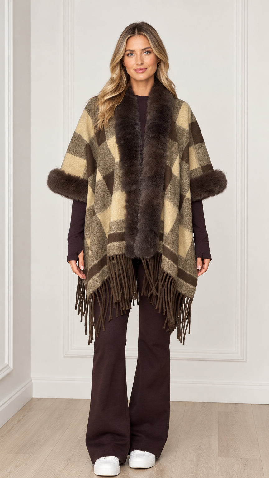 Woman wearing olive khaki plaid poncho with faux fur collar and fringe hem - front view
