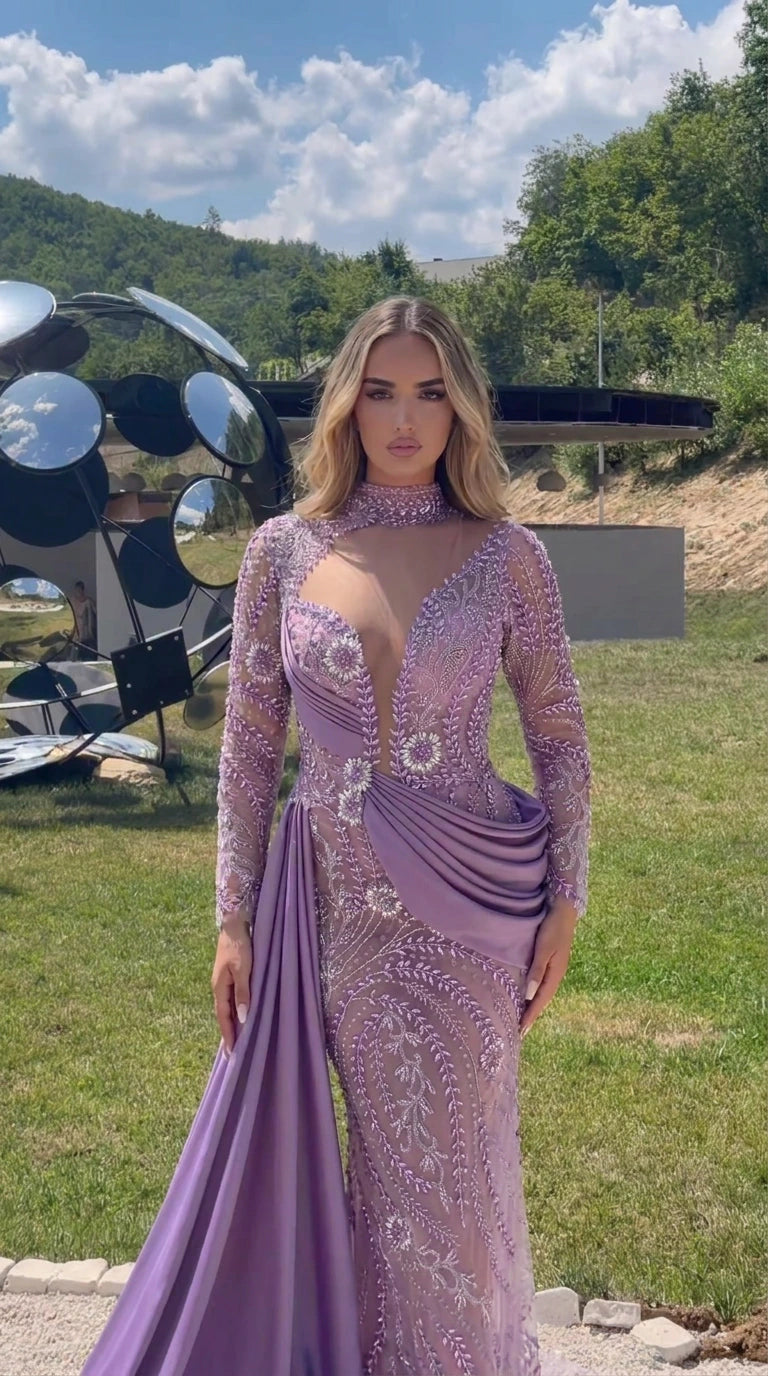 Front view of model wearing a lilac beaded high neck long sleeve evening gown with draped waist sash