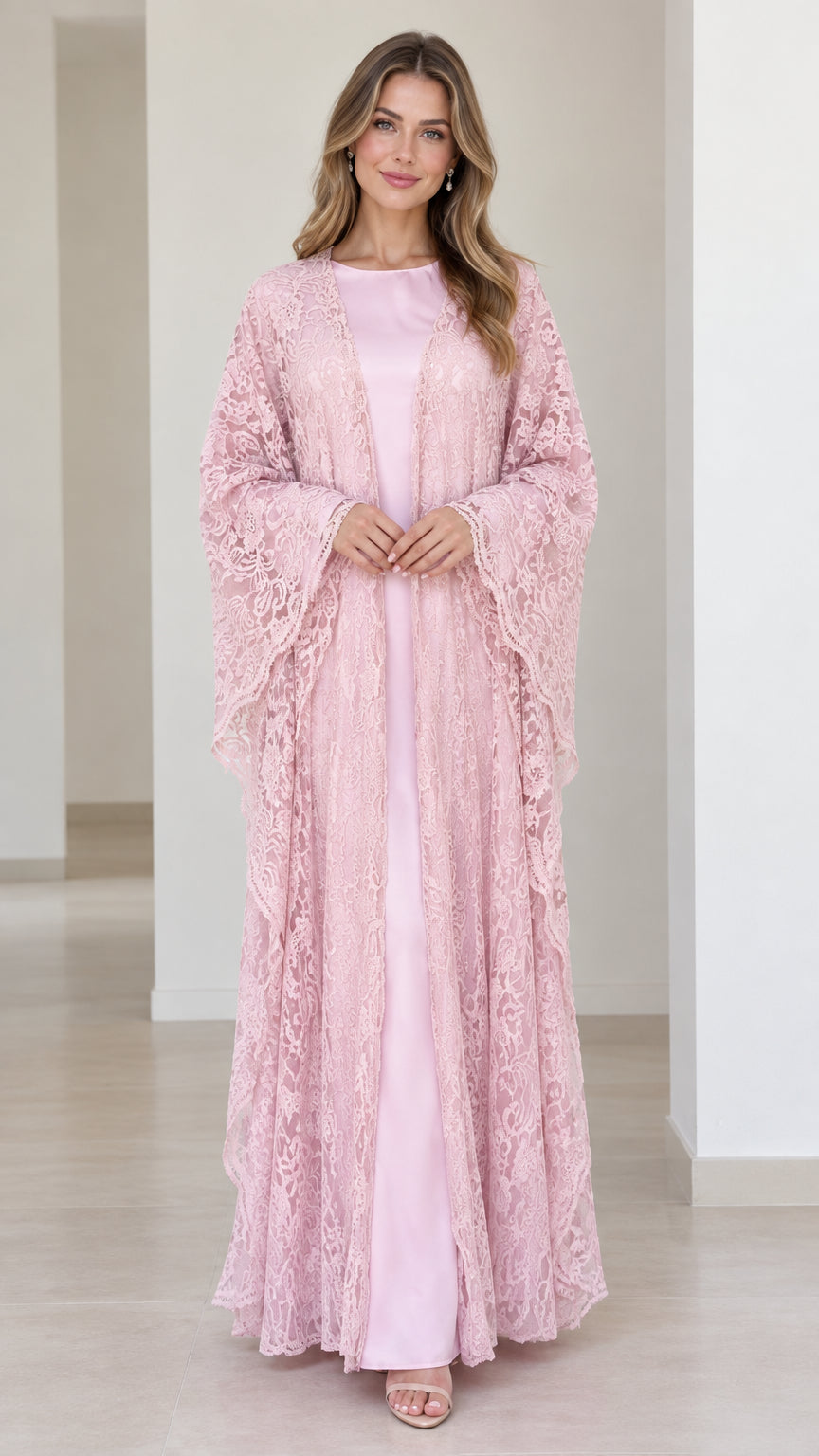 Full front view of model wearing blush pink floral lace overlay maxi dress set with draped sleeves