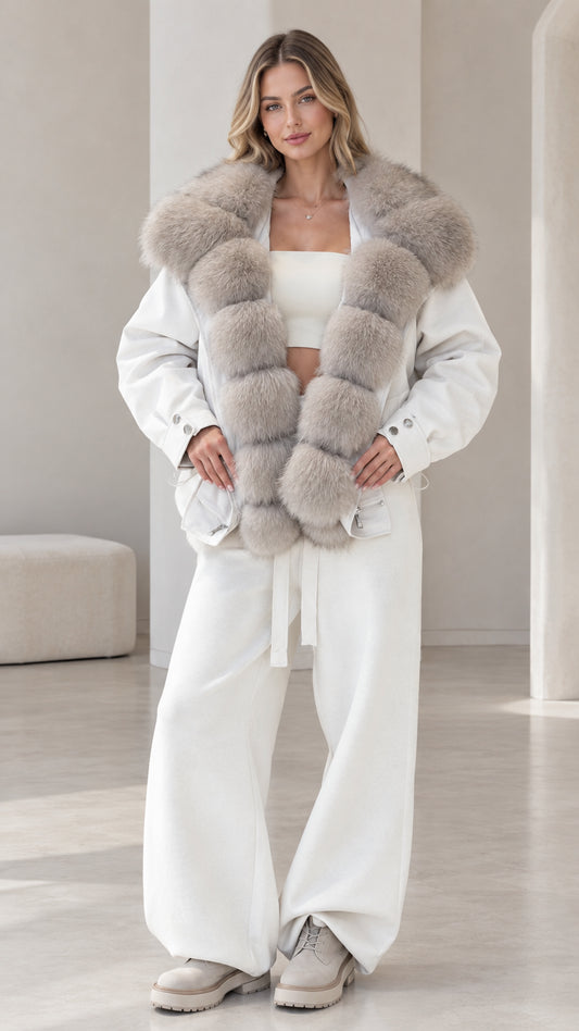 Front view of model wearing white zip-up jacket with grey plush faux fur collar and matching wide-leg pants