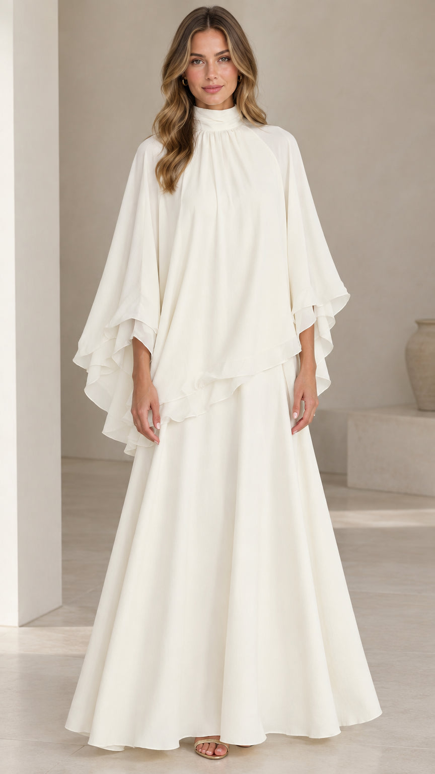 Front full-length view of model wearing ivory white high neck capelet maxi dress set