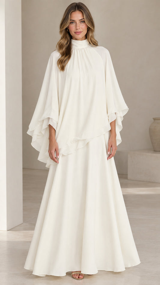 Front full-length view of model wearing ivory white high neck capelet maxi dress set